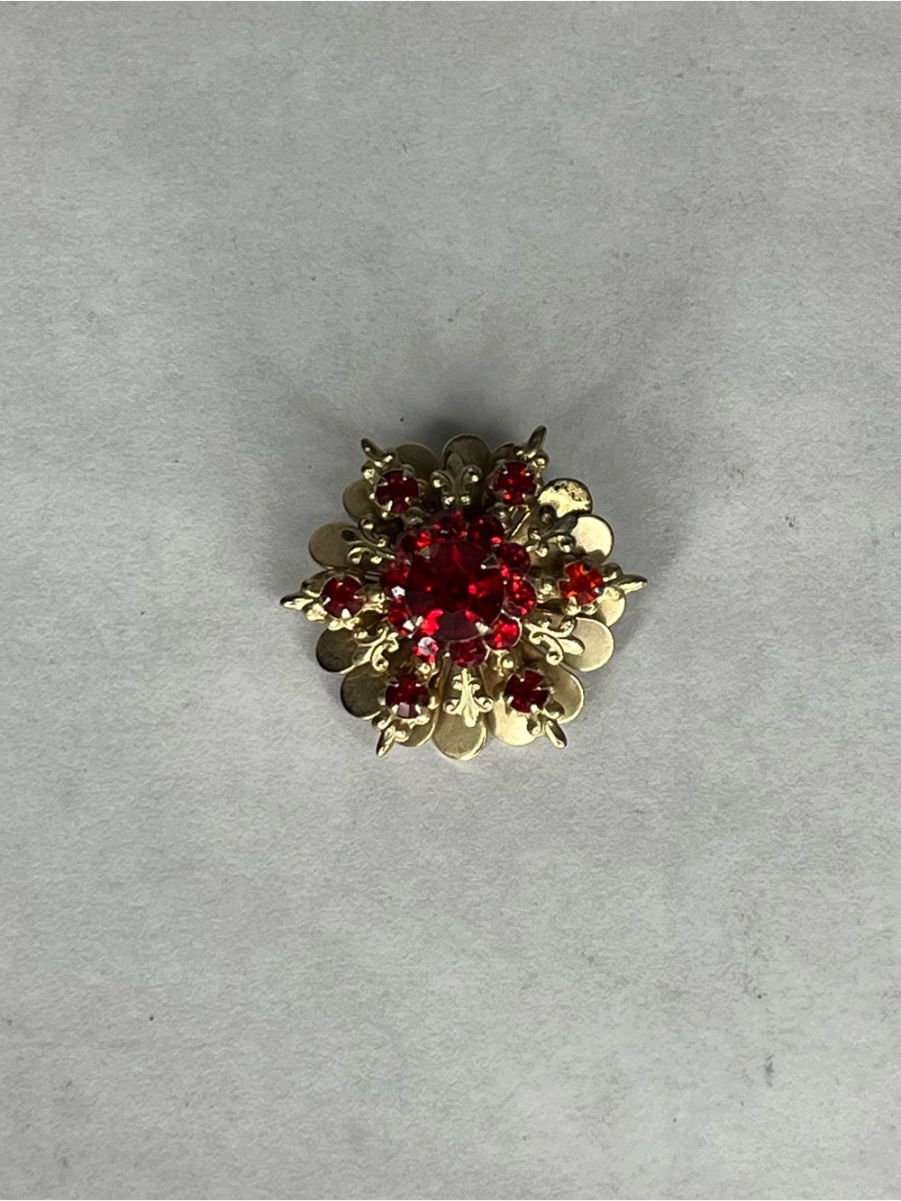 Round gold and ruby broach